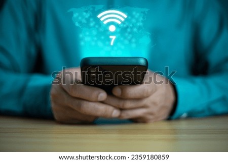 Business Man using smart phone with wifi technology 7 , connecting to the internet world with new technology.
