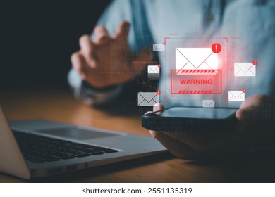 Business man using smartphone and computer that show warning sign after got attack phishing email by malware from hacker that commit cyber crime or software crash to cause an error.