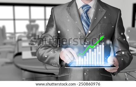 business man using tablet computer to work with financial data