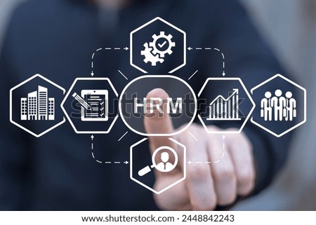 Business man using virtual interface sees acronym: HRM. Human Resource Management ( HRM ) Business concept. Human development recruitment leadership and customer target concept.