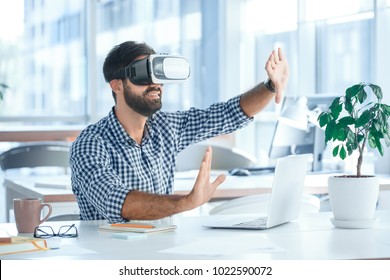 Business man using virtual reality headset in the office - Powered by Shutterstock