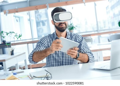 Business man using virtual reality headset in the office - Powered by Shutterstock