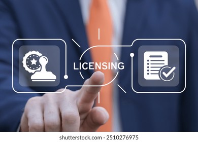 Business man using virtual touch interface presses word: LICENSING. License agreement business technology concept. Copyright protection law license property rights.