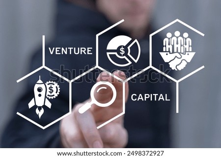 Business man using virtual touch screen sees inscription: VENTURE CAPITAL. Venture Capital Funding Business concept.