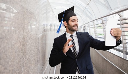 Business man video call to his family for successful graduation and wear graduation hat, business education concept in the cityscape. Business education. - Powered by Shutterstock