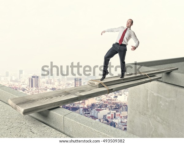 business man walk on\
danger improvised\
bridge