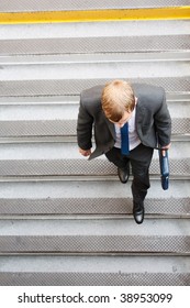 A Business Man Walking Down Some Steps