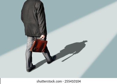 Business Man Walking With His Shadow