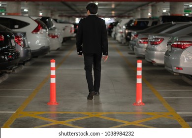 Business Man Walking On Walk Way In Car Park  Of Airport Parking Lot.