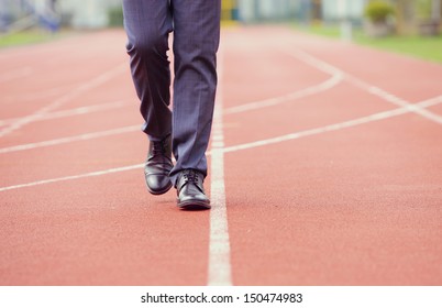 A Business Man Is Walking In The Running Track, Close Up