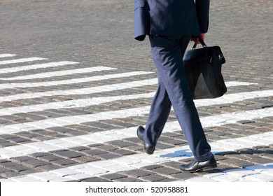 Business Man Walks On A Pedestrian Crossing