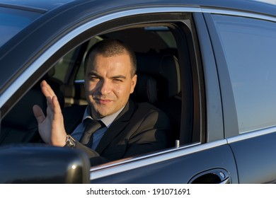 Business Man Waving From A Car Window