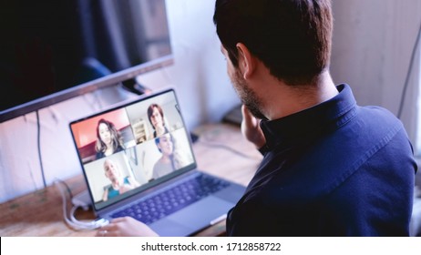 Business Man Waving At Screen During Virtual Call Meeting With His Work Teammates.  COVID-19 Coronavirus Work From Home Concept.