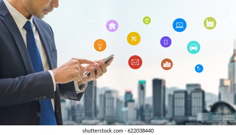 Business Man Wear Suit Using Mobile Phone Control Internet Of Things Features Diagram Icon With Blur City Skyline Modern Building At Background,Digital Technology Concept