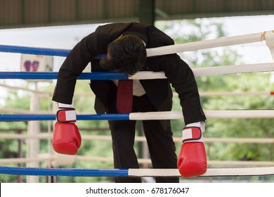 Business Man Wearing Boxing Glove Loser Knock-out And Body Hanging On The Rope Feeling So Stressed And Tried,Business Failed And Loss Concept