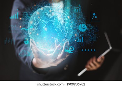Business man wearing a suit using a tablet hand presenting cyber business world graphics In the business technology model, the concept of digital business processing