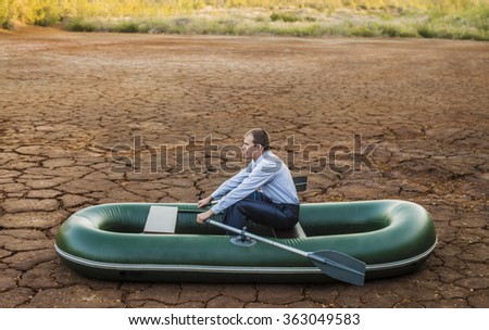 Business man will rows home for shore in paddle powered row boat businessman in boat rocks looks bright future symbol crisis stagnation losses braking environmental disaster water scarcity drought
