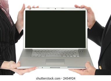 Business Man And Woman Holding Open Laptop With Screen Facing Camera.