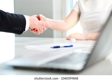 Business Man And Woman Shaking Hands After Successful Job Interview Or Meeting. Young Applicant Making Contract Of Employment. Employer Hiring New Employee. Handshake In Office. Recruitment Of Intern.