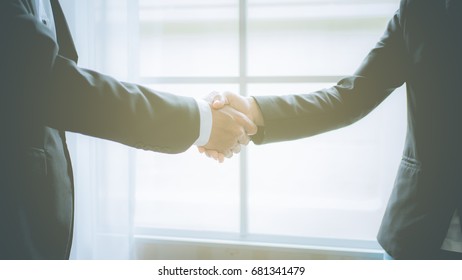  Business man and business woman shaking hands, teamwork concept