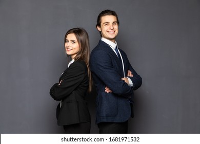 Business Man And Woman Standing Back To Back Isolated On Gray Background.