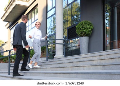 Business man and woman walking in the office center. - Powered by Shutterstock