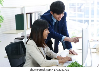 Business Man And Business Woman Work Happily Together At The Work Area In The Office