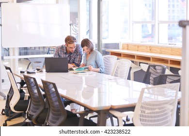 Business Man And Woman Working Together In Conference Room