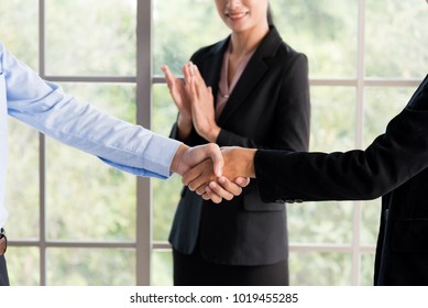 business man and women are shaking hand - Shutterstock ID 1019455285