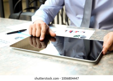 Business Man Working And Analyzing Financial Figures On A Graphs On A Laptop Outside