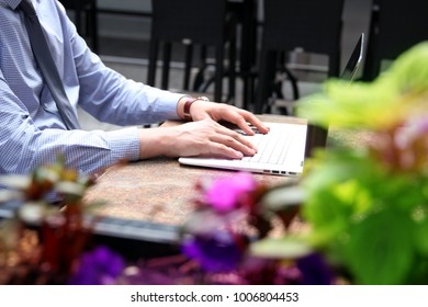 Business Man Working And Analyzing Financial Figures On A Graphs On A Laptop Outside