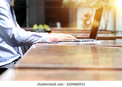 Business Man Working And Analyzing Financial Figures On A Graphs On A Laptop Outside