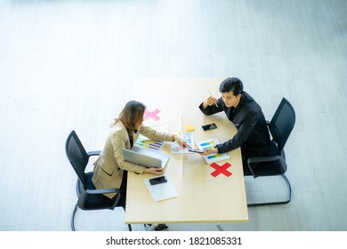 Business Man Working Apart From Colleague  In The Office. New Normal Social Distancing Concept.