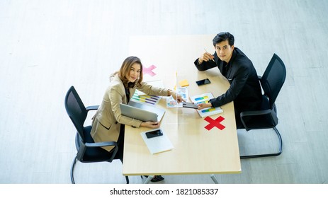 Business Man Working Apart From Colleague  In The Office. New Normal Social Distancing Concept.