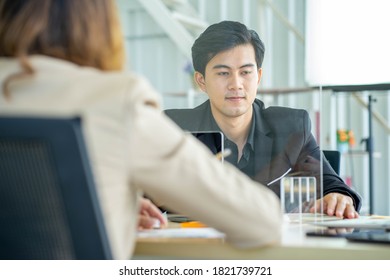 Business Man Working Apart From Colleague  In The Office. New Normal Social Distancing Concept.