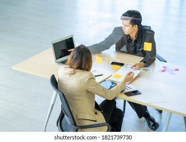 Business Man Working Apart From Colleague  In The Office. New Normal Social Distancing Concept.