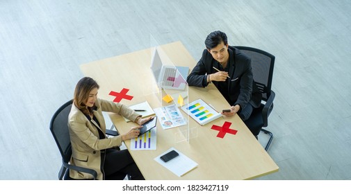 Business Man Working Apart From Colleague  In The Office. New Normal Social Distancing Concept.