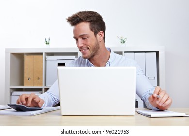 Business Man Working With Laptop And Calculator In Office