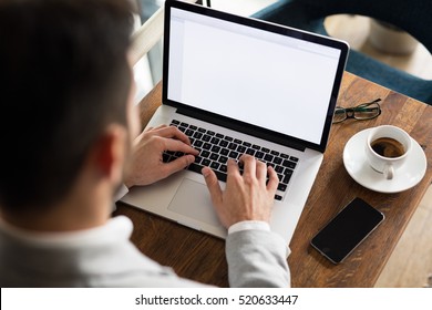 Business Man Working With Laptop At City Cafe.