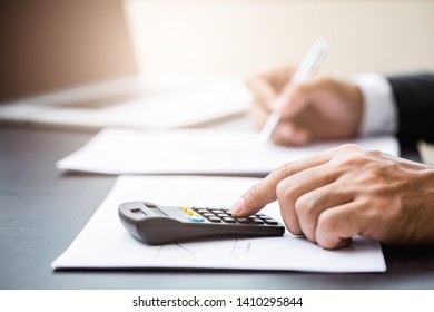 Business man working at office with laptop and documents on his desk - Shutterstock ID 1410295844