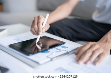 Business man working on digital tablet Graphic designer drawing on graphic tablet creative studying work at home - Powered by Shutterstock