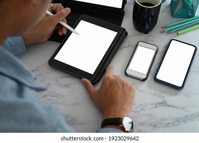 Business man working online with multiple devices on marble table.