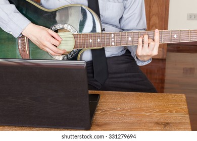 Business Man Working Using Laptop Computer And Play Guitar