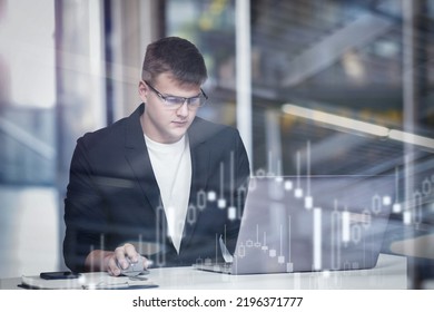 Business man works in the office and analyzes the trading market at the computer. - Shutterstock ID 2196371777