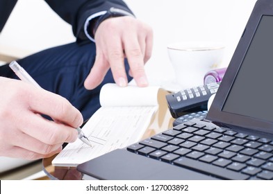 A Business Man Writing A Bank Check