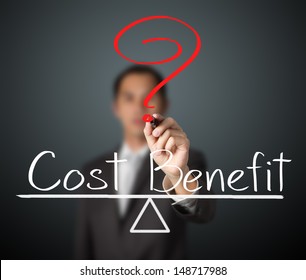 Business Man Writing Cost And Benefit Compare On Balance Bar