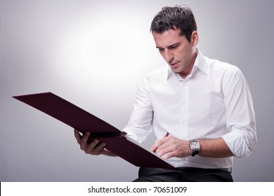 Business Man Writing On Financial Book