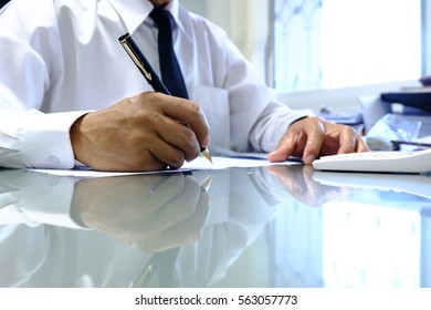 Business man writing something about business on the paper close up - Shutterstock ID 563057773