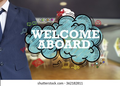 business man writing WELCOME ABOARD  over the cloud with office background , business concept , business idea
