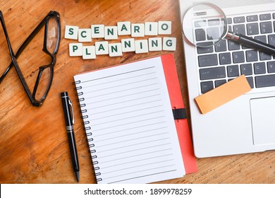 Business And Management Concept.  Top View Of Block Letters On Scenario Planning On The Wooden Table With A Notebook, Pen, Eyeglasses, Label And Magnifying Glass On The Laptop Keyboard  